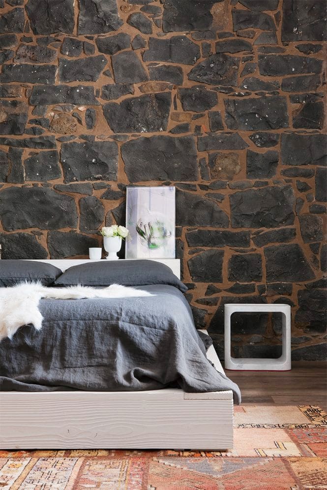 11: Raw Elegance: Black Exposed Stone in Black Furniture Bedroom Ideas