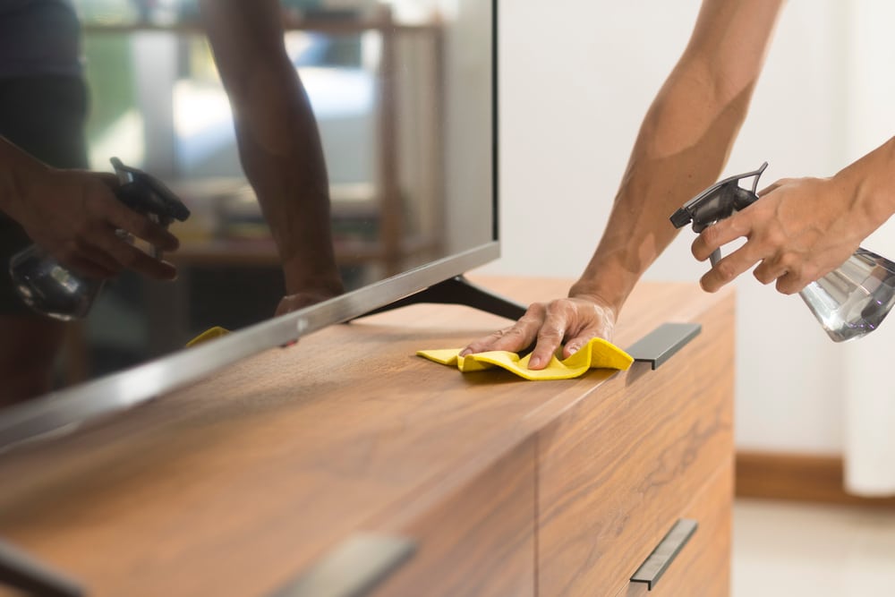 Cleaning Home Wood Cabinet Table Surface With Disinfectant Spray Bottle