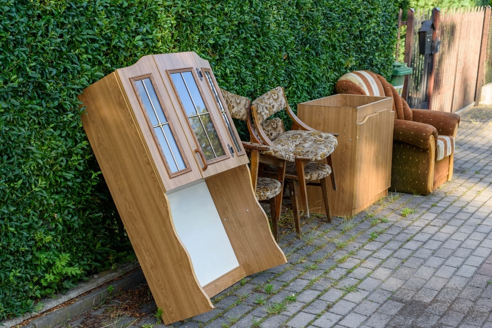 Items And Old Furniture On Street Outside House Moving Day