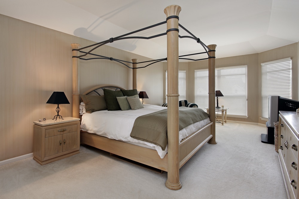 Master Bedroom In Suburban Home With Oak Wood Bed Frame