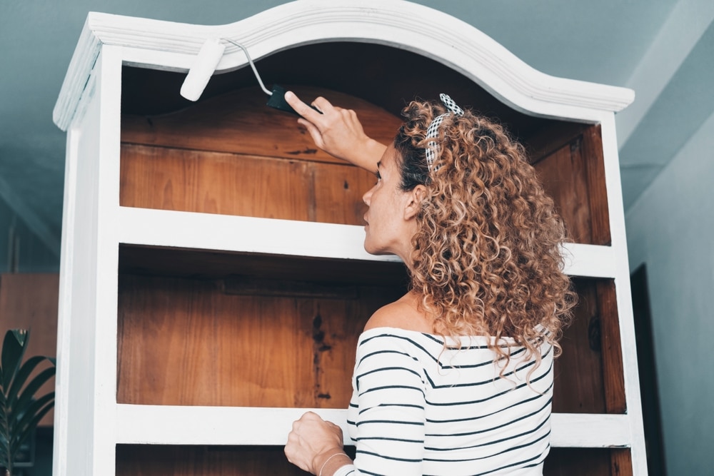 One Woman At Home Painting To Renovate Old Cabinet Furniture