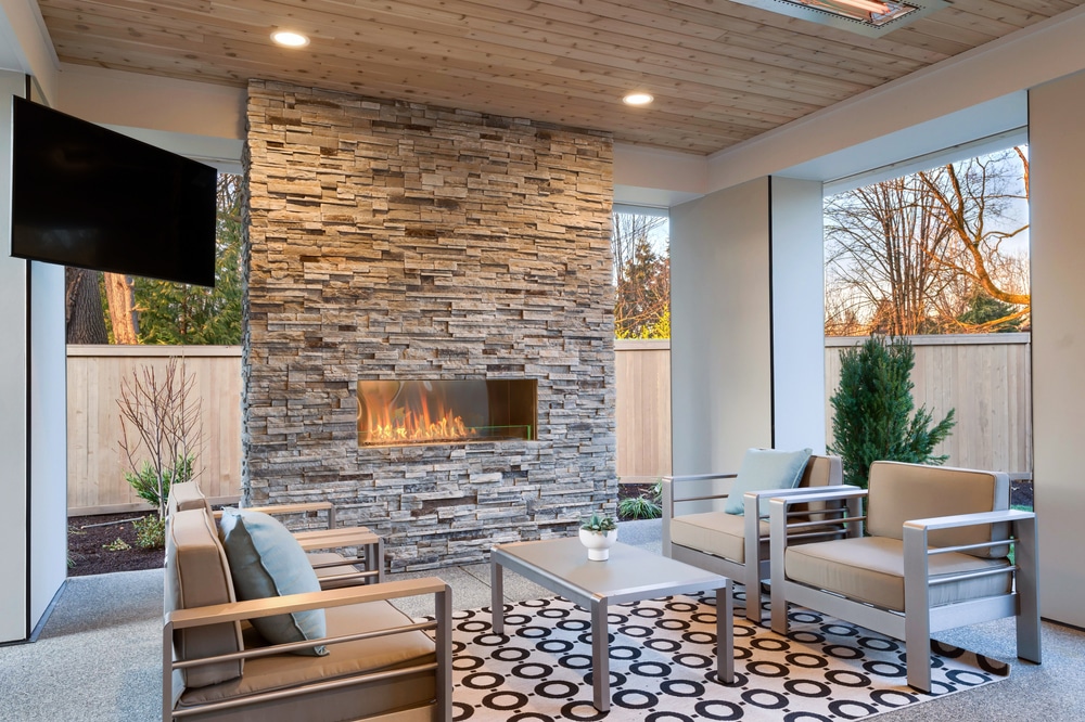 Luxury Outdoor Relaxing Living Room With Large Stone Fireplace Tv