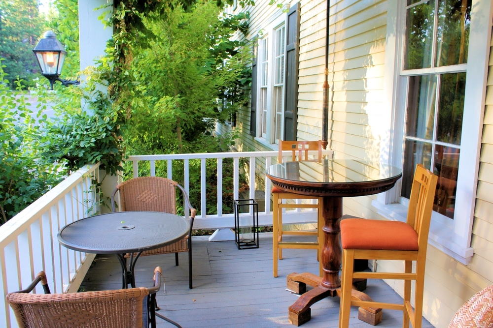 Patio Furniture On The Front Porch Of A Colonial Home