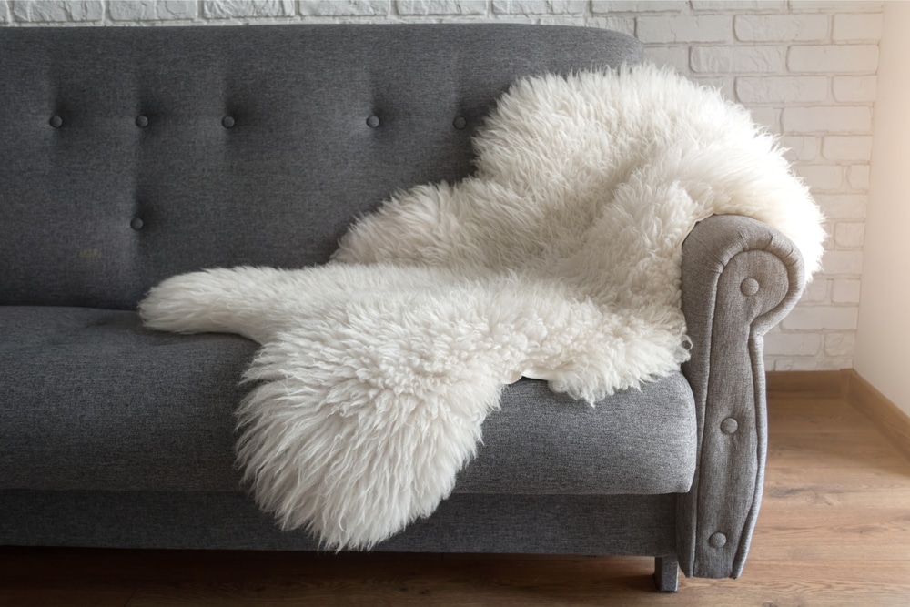 White sheep skin on a gray sofa