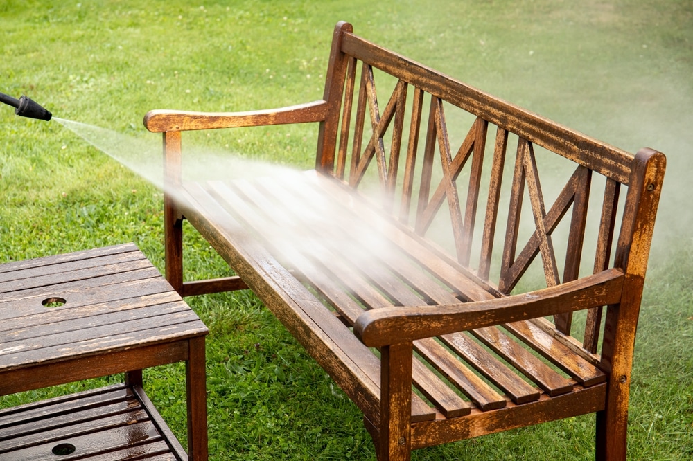 Close Up View Of Person Working Cleaning Pressure Washing Wooden