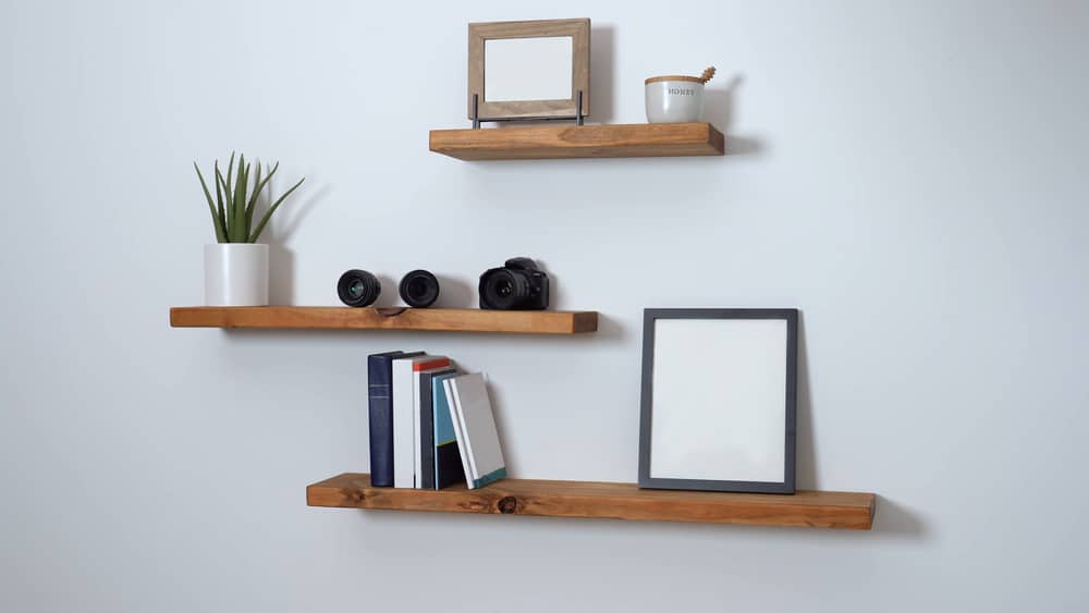 floating shelve swith planter books and frames