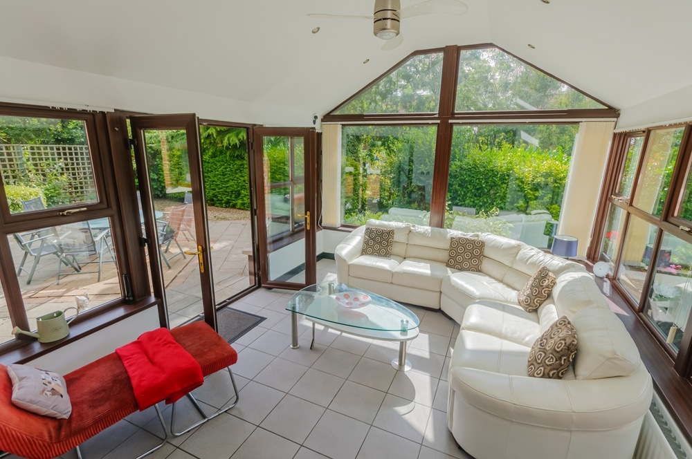 Sunroom In A Modern Bungalow With A White Leather Sofa