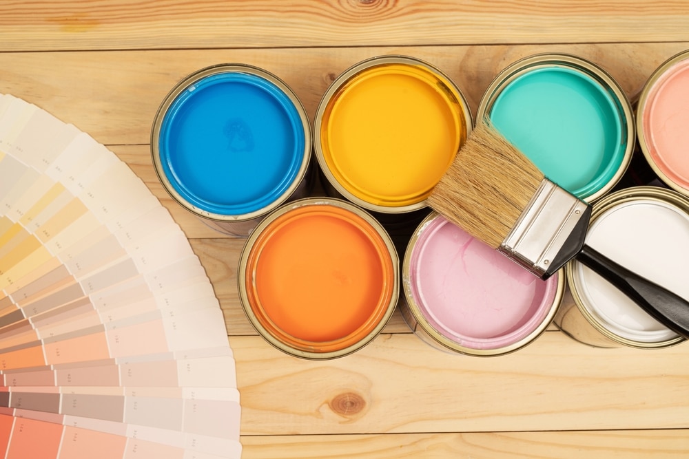 different types of paints and a brush