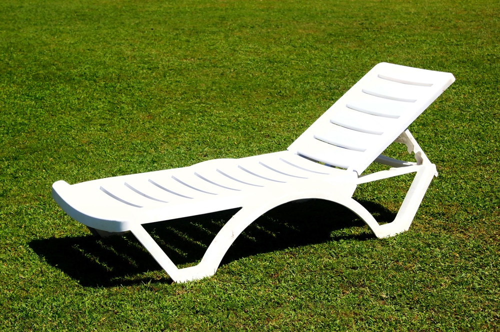 White Chaise Lounge On Green Grass