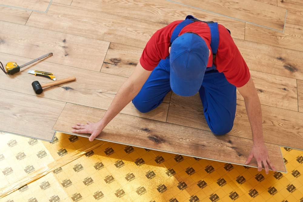 Vinyl Floor Installation Close up Hands Of Worker At Home Flooring