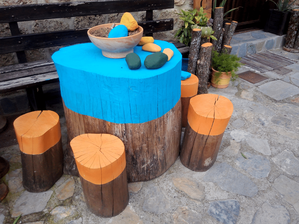 the diy stool and table in the garden made up of log wood